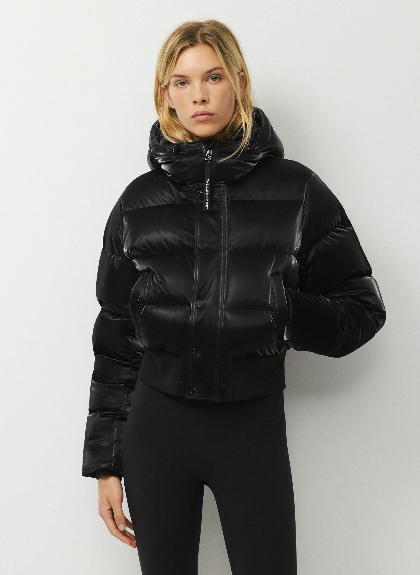 The Super Chalet Puff zipped to the chin, zipper pull tag visible.